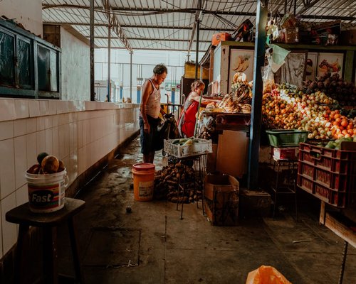 Person buying fresh produce at a vibrant local Peruvian market