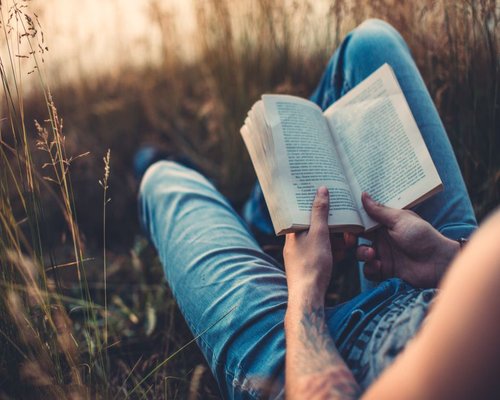 Person reading a book peacefully on a weekend